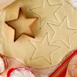 gluten free sugar cookie dough rolled out being cut into stars